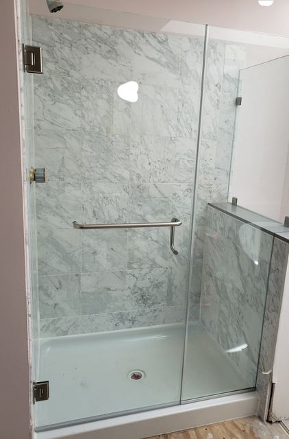Custom glass shower enclosure installed by Battlefield Glass