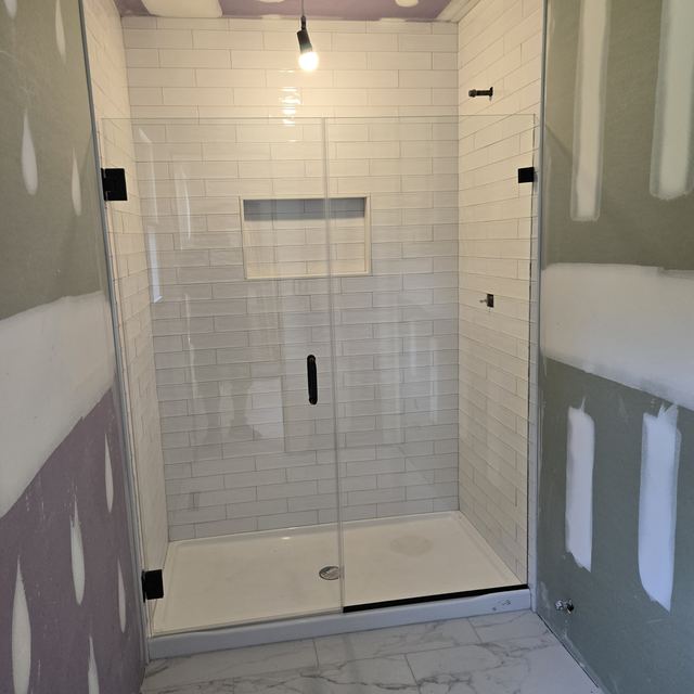 Custom glass shower enclosure installed by Battlefield Glass