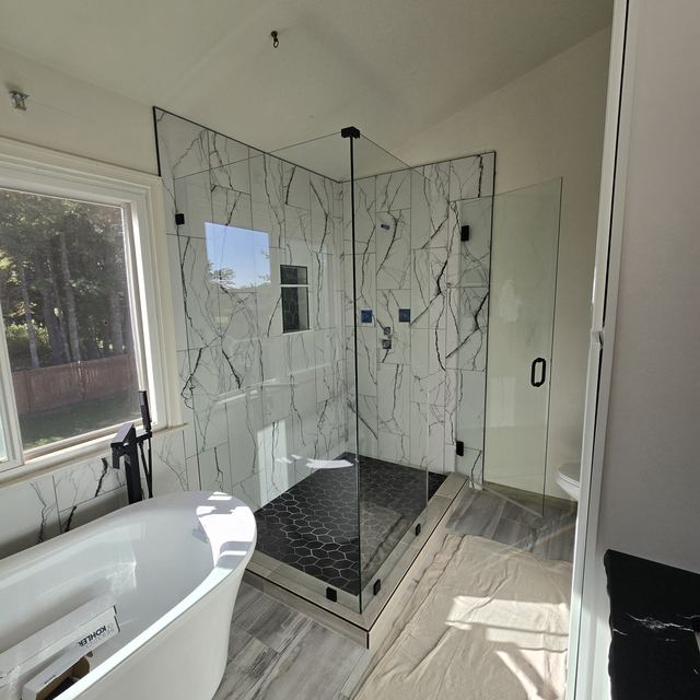 Custom glass shower enclosure installed by Battlefield Glass