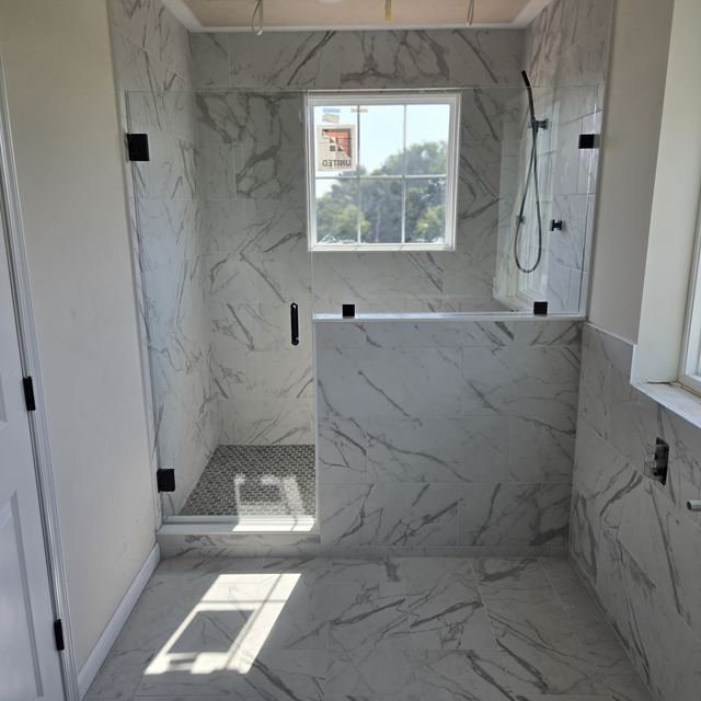 Custom glass shower enclosure installed by Battlefield Glass